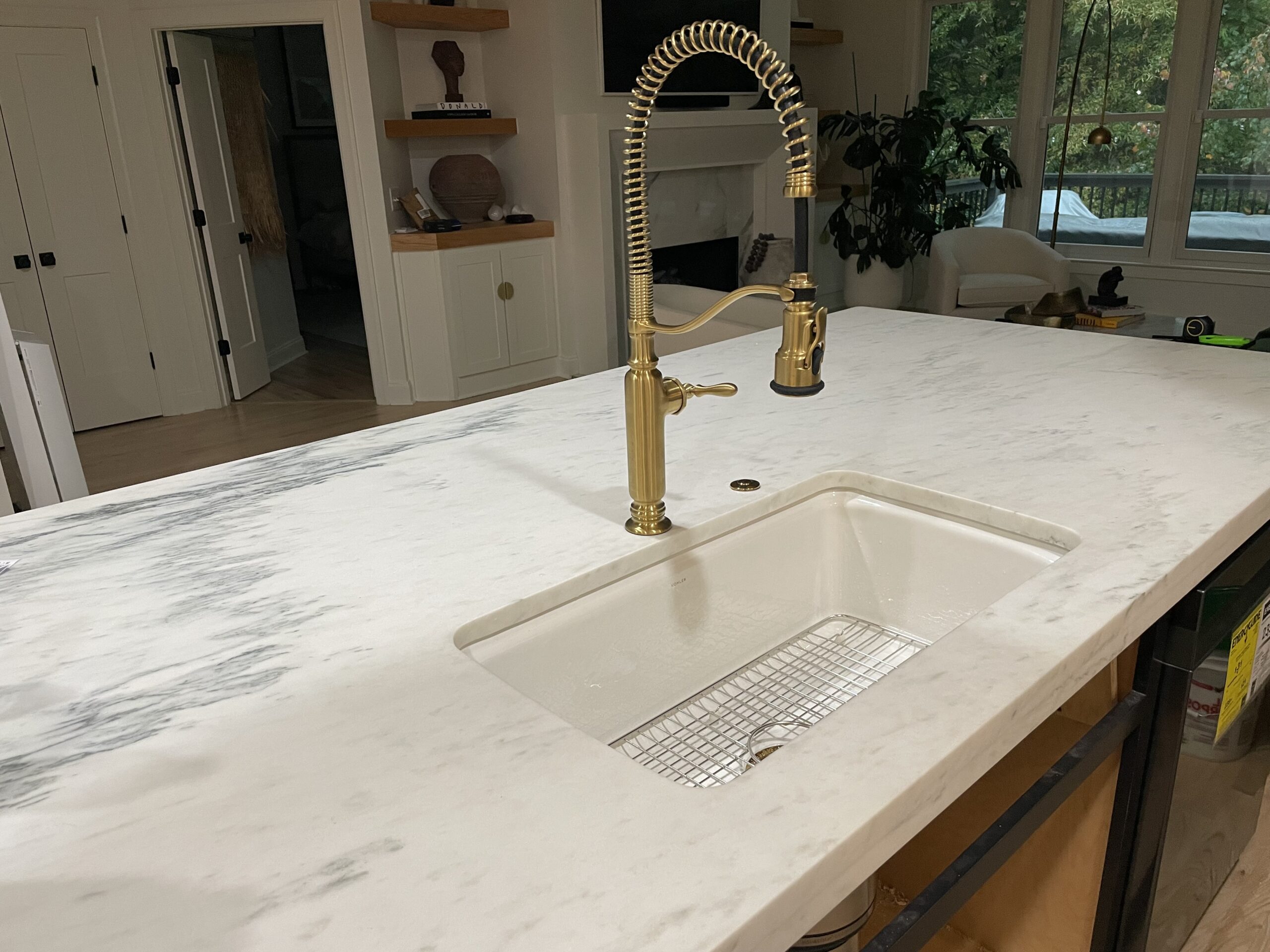 Gold faucet in a beautifully finished kitchen